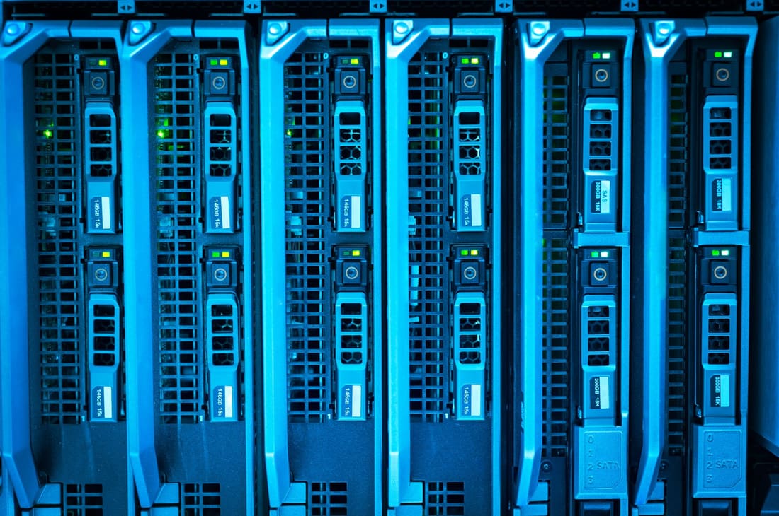Rows of illuminated equipment racks in a data centre hall