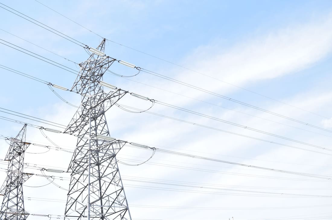 Transmission tower and conductors against an open sky